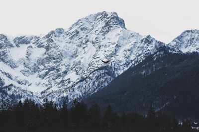 Scenic view of snowcapped mountains against clear sky