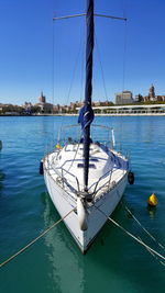 Boats moored in sea against clear sky