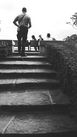 Full length of woman standing on railing