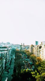 High angle view of street amidst buildings against clear sky