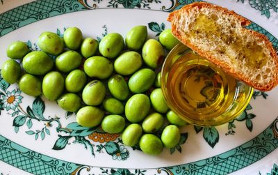 Fresh olives and olive oil with bread of a plate