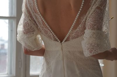 Midsection of bride standing by window at home