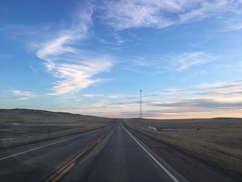 Road passing through landscape against sky