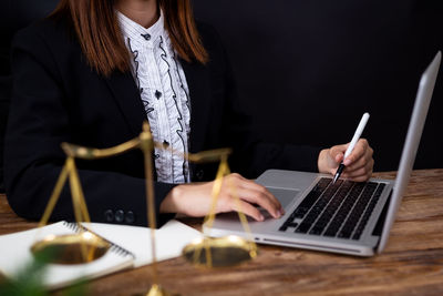 Midsection of woman using mobile phone