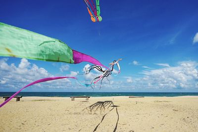 Scenic view of beach against blue sky