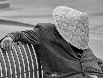 Rear view of person wearing hat against railing