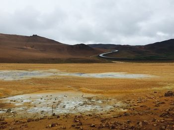 Scenic view of lake against cloudy sky