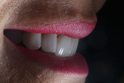 Extreme close up of woman with pink lips