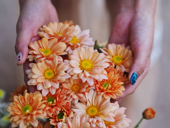 Close-up of woman holding bouquet of flowering plant