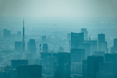 Aerial view of buildings in city against sky