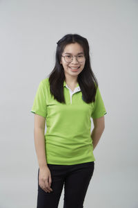 Portrait of a smiling young woman against white background