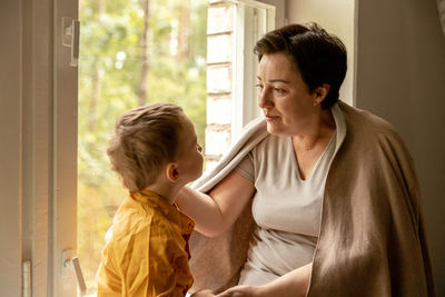 Happy grandmother and grandson enjoy time together. positive middle age woman 