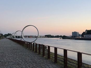 Scenic view of river against clear sky during sunset