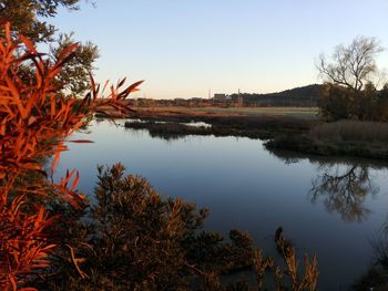 Scenic view of lake against sky at sunset