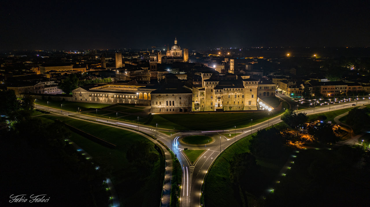 HIGH ANGLE VIEW OF ILLUMINATED BUILDINGS IN CITY