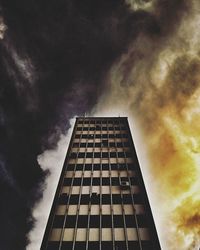 Low angle view of modern building against cloudy sky