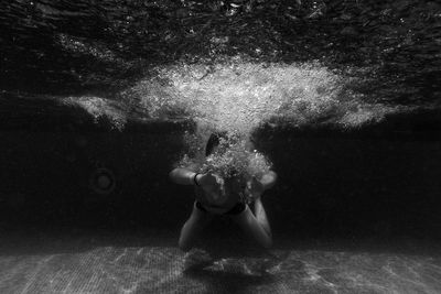 Front view of person swimming in pool