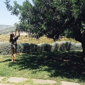 Woman standing on grassy field