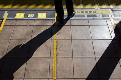 Silhouette of someone waiting for the train on a train platform in tokyo