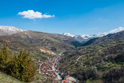 Scenic view of mountains against blue sky