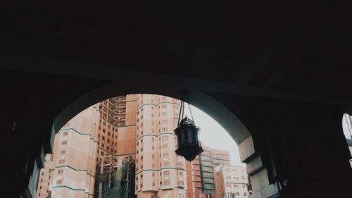 Low angle view of hanging amidst buildings in city