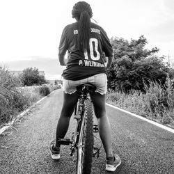 Man riding bicycle on road