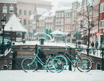 Bicycles on street against buildings in city