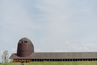 Built structure on field against sky