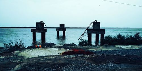 Pier over sea against clear sky