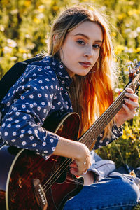 Young woman playing guitar