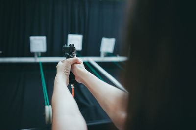 Close-up of hand holding camera on table