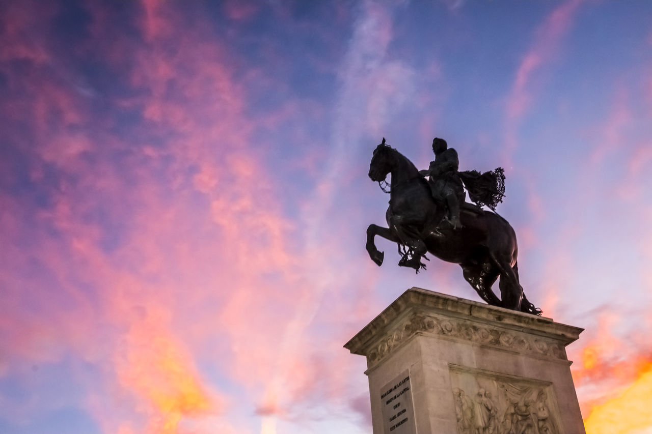 horse, sculpture, statue, sky, representation, architecture, human representation, cloud, livestock, animal representation, nature, memorial, domestic animals, history, the past, male likeness, low angle view, monument, no people, sunset, travel destinations, city, craft, creativity, built structure, mammal, outdoors, travel, animal, art, silhouette