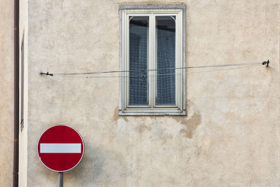 Road sign on wall of building