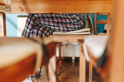 Midsection of woman sitting on chair