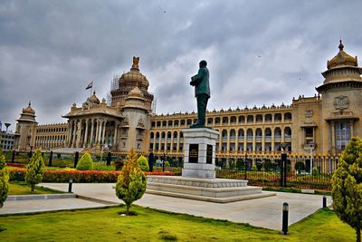 Statue of historic building against cloudy sky