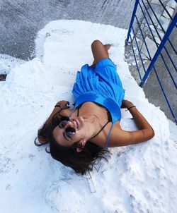 High angle view of woman lying on steps