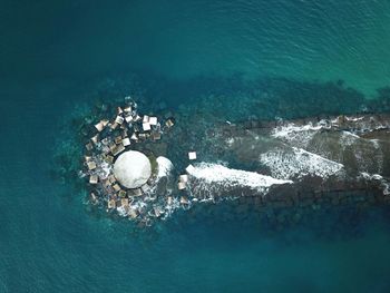 Aerial view of damaged pier in sea
