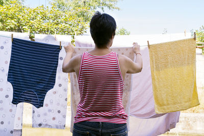 Rear view of woman standing against the sky