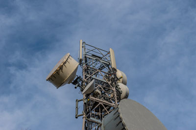 Low angle view of communications tower against sky