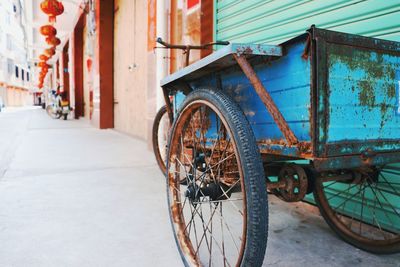 View of rusty rickshaw on street