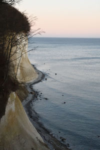 Scenic view of beach against sky during sunset