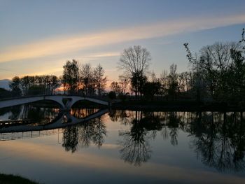 Reflection of trees in lake during sunset