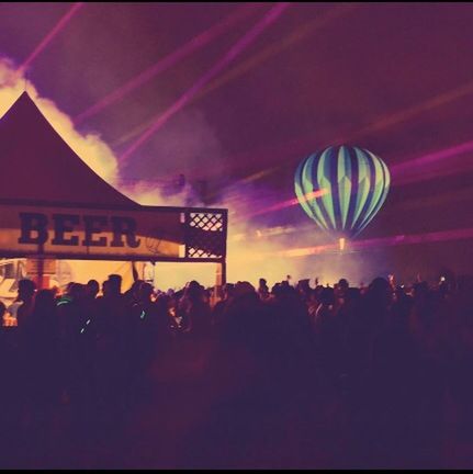 large group of people, illuminated, arts culture and entertainment, night, silhouette, crowd, enjoyment, lifestyles, sky, celebration, leisure activity, person, fun, men, event, lighting equipment, pink color, multi colored, light - natural phenomenon