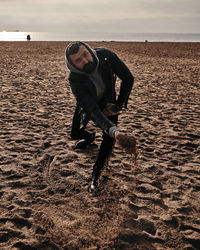 Young man running on beach