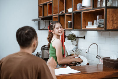 Side view of young woman working in office