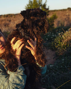 Cropped hand of girl with dog