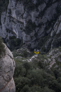 Moody green lush yellow cable car in spain