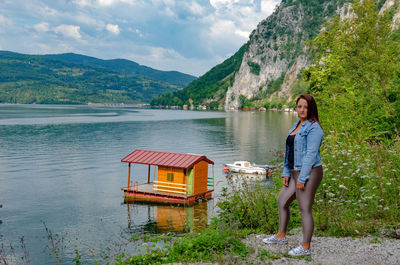 Portrait of woman standing by lake