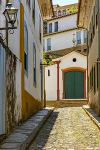 Empty alley amidst buildings in city