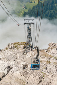 Overhead cable car on mountain against sky